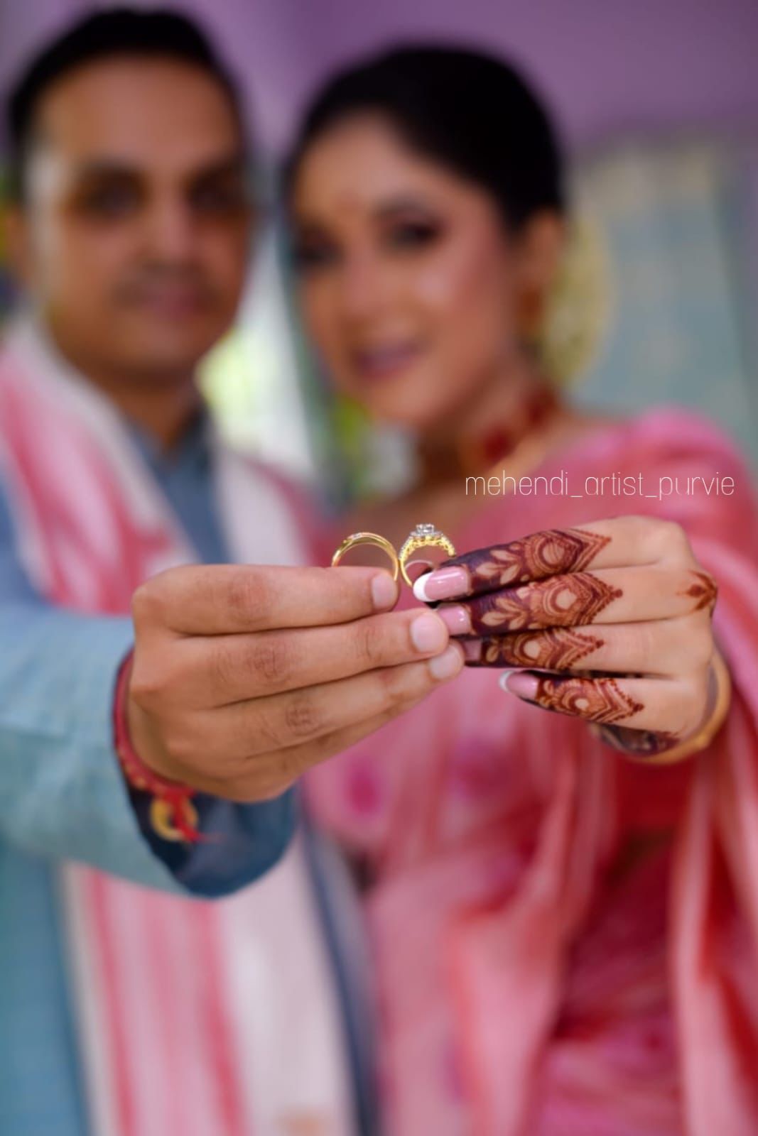 Close-up of finger focused bridal henna with rings